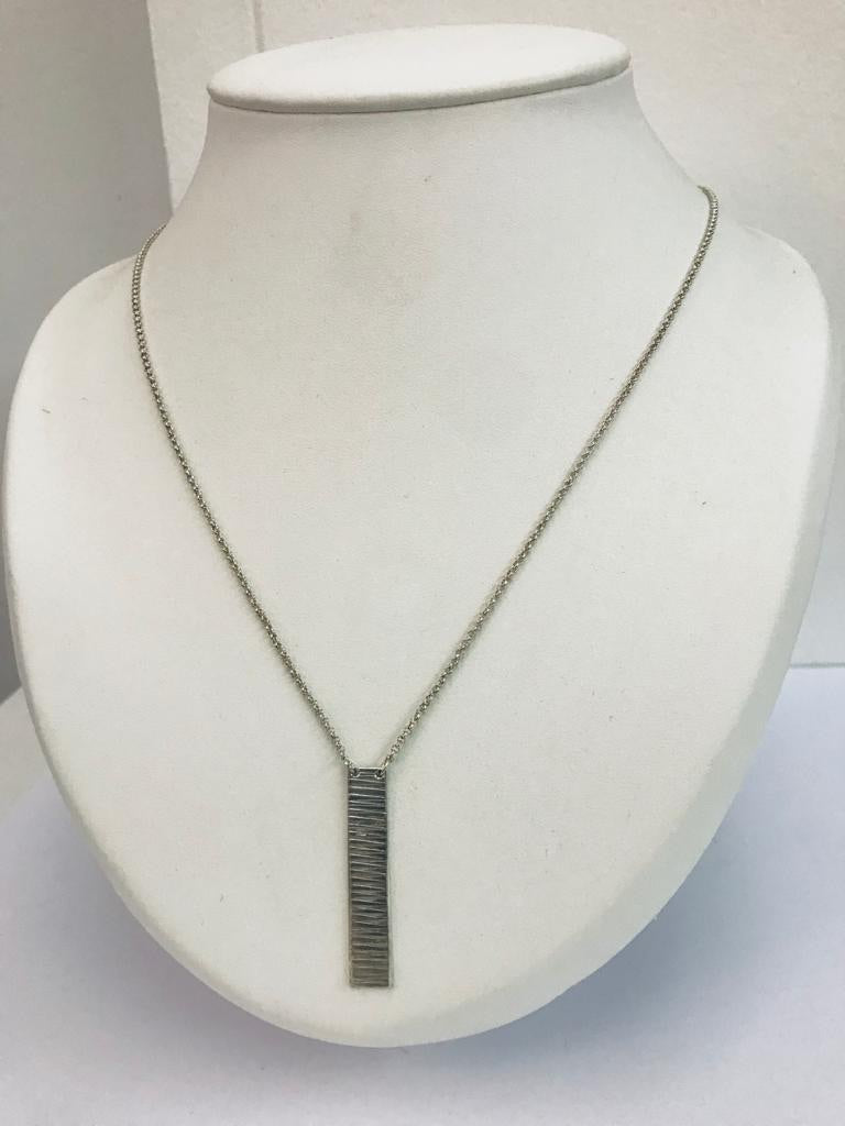 Silver matte embossed necklace by designer Anke.